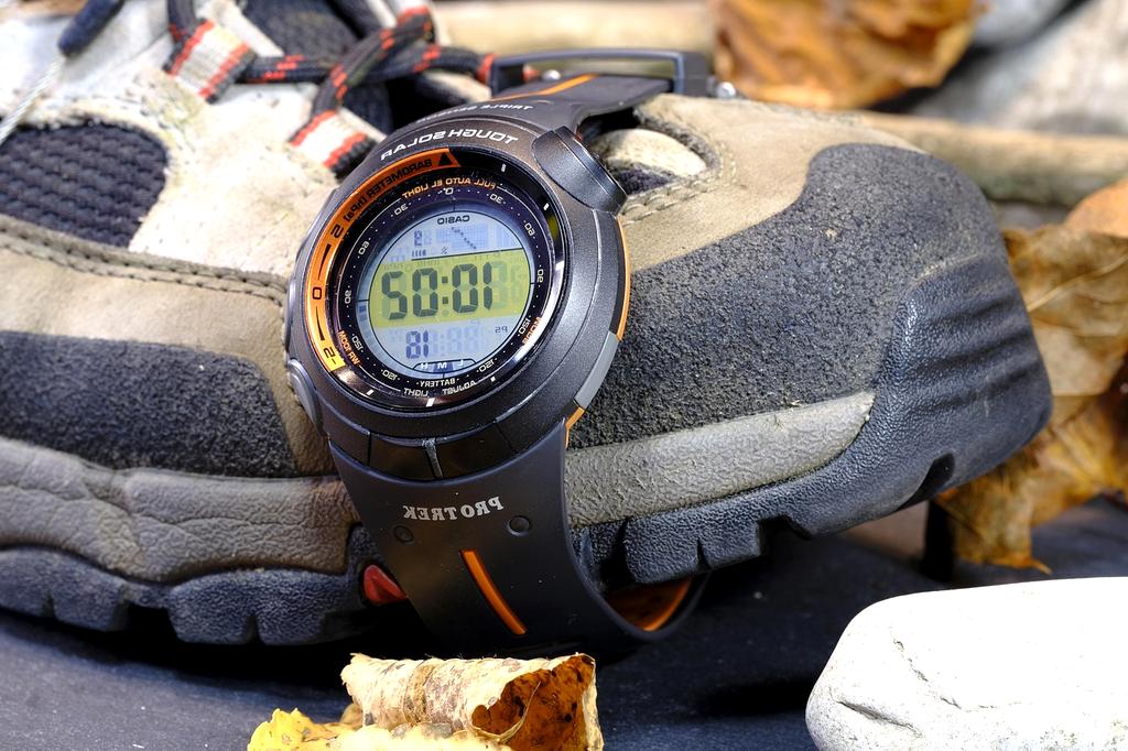 Professional marathon coach Sarah Martinez using timing tools during training session